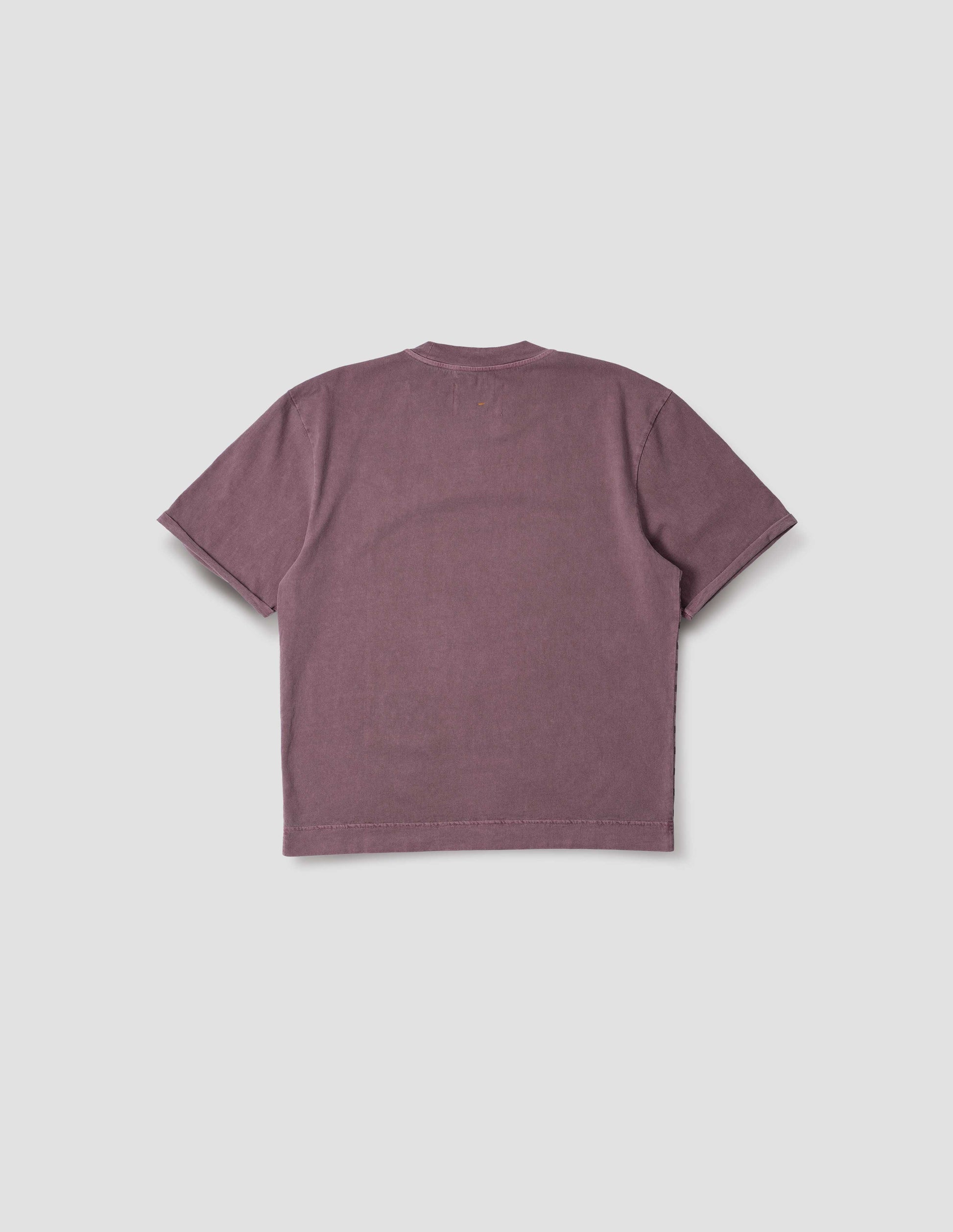Purple short sleeve cotton t-shirt with flatlock stitch seam detailing and rolled raw sleeve hems held with a single bar tack. Back flat lay view.
