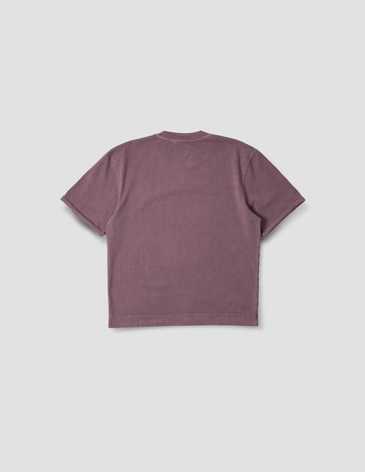 Purple short sleeve cotton t-shirt with flatlock stitch seam detailing and rolled raw sleeve hems held with a single bar tack. Back flat lay view.
