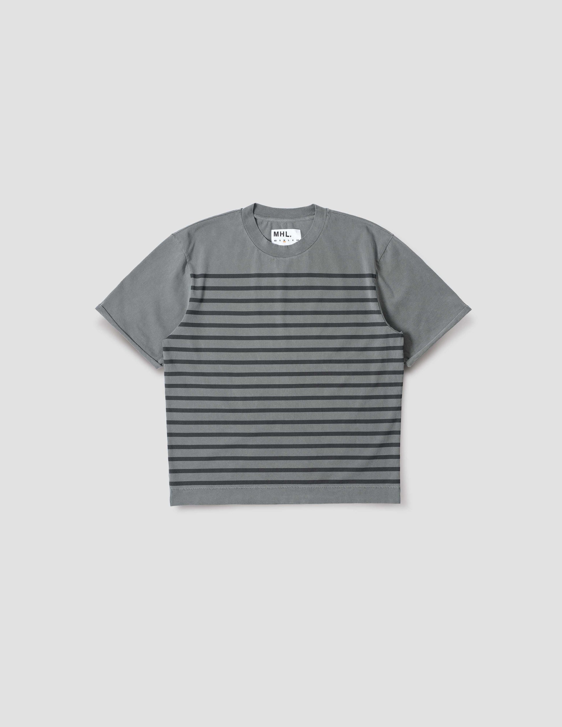 Blueish grey short sleeve t shirt with black stripes, flatlock stitch seam detailing and rolled raw sleeve hems held with a single bar tack. Front flat lay view. 
