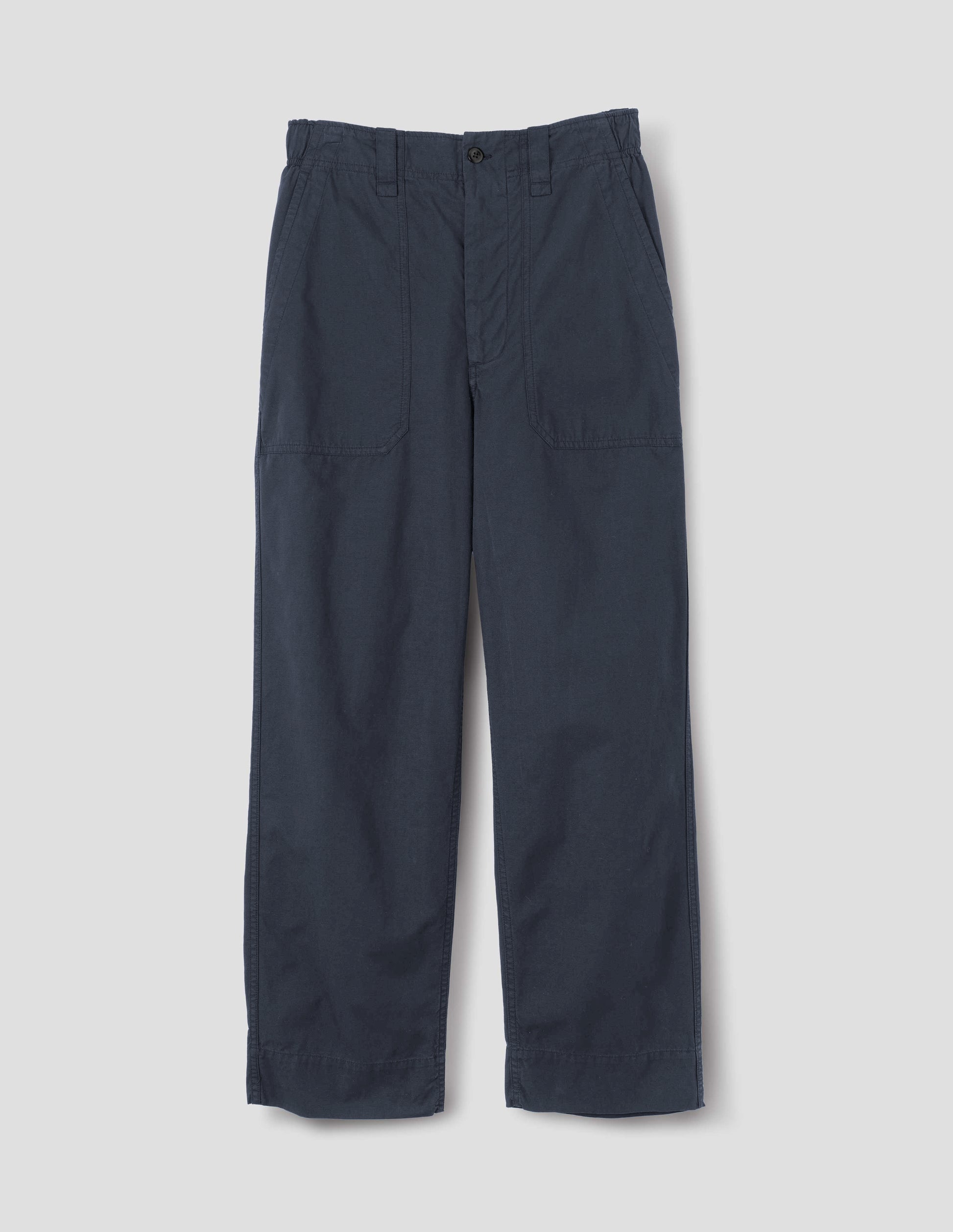 Dark blue trousers with sewn-in patch pockets, half-elasticated waistband, belt loops and corozo brace button fastening. Front flat lay view. 