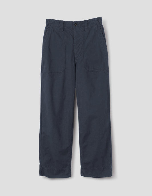 Dark blue trousers with sewn-in patch pockets, half-elasticated waistband, belt loops and corozo brace button fastening. Front flat lay view. 