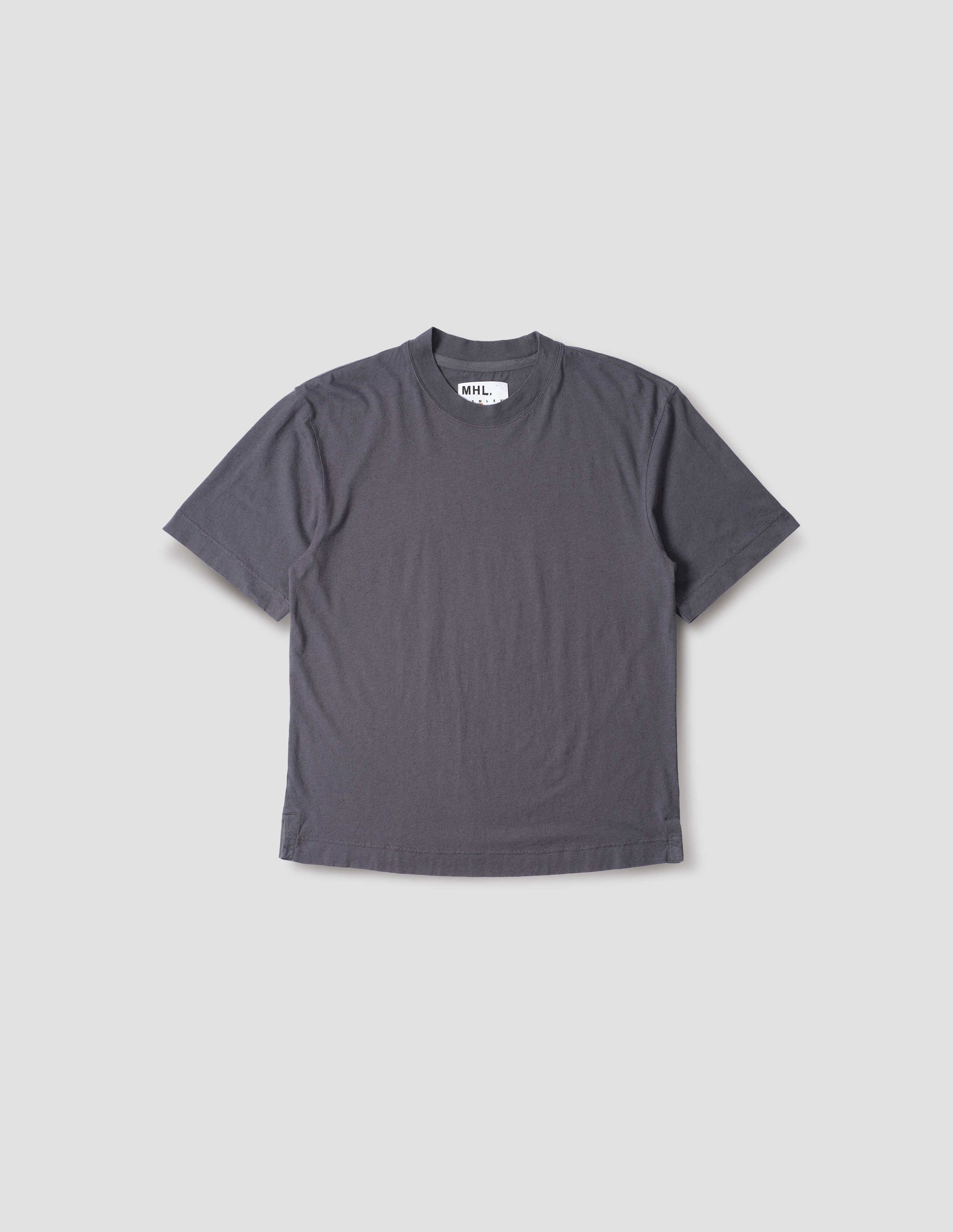 Greyish blue cotton linen short sleeve t-shirt with vent split hem and herringbone tape detailing inside the neck. Front flat lay view.