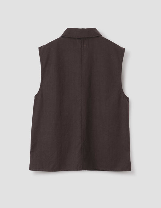 Dark brown cotton drill sleeveless overshirt, with centre seam detailing down back and vent split hem. Back flat lay view.