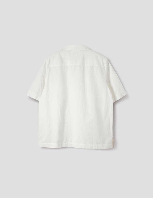 White cotton and linen short sleeve shirt, with side split hem with contrasting herringbone tape. Back flat lay view.