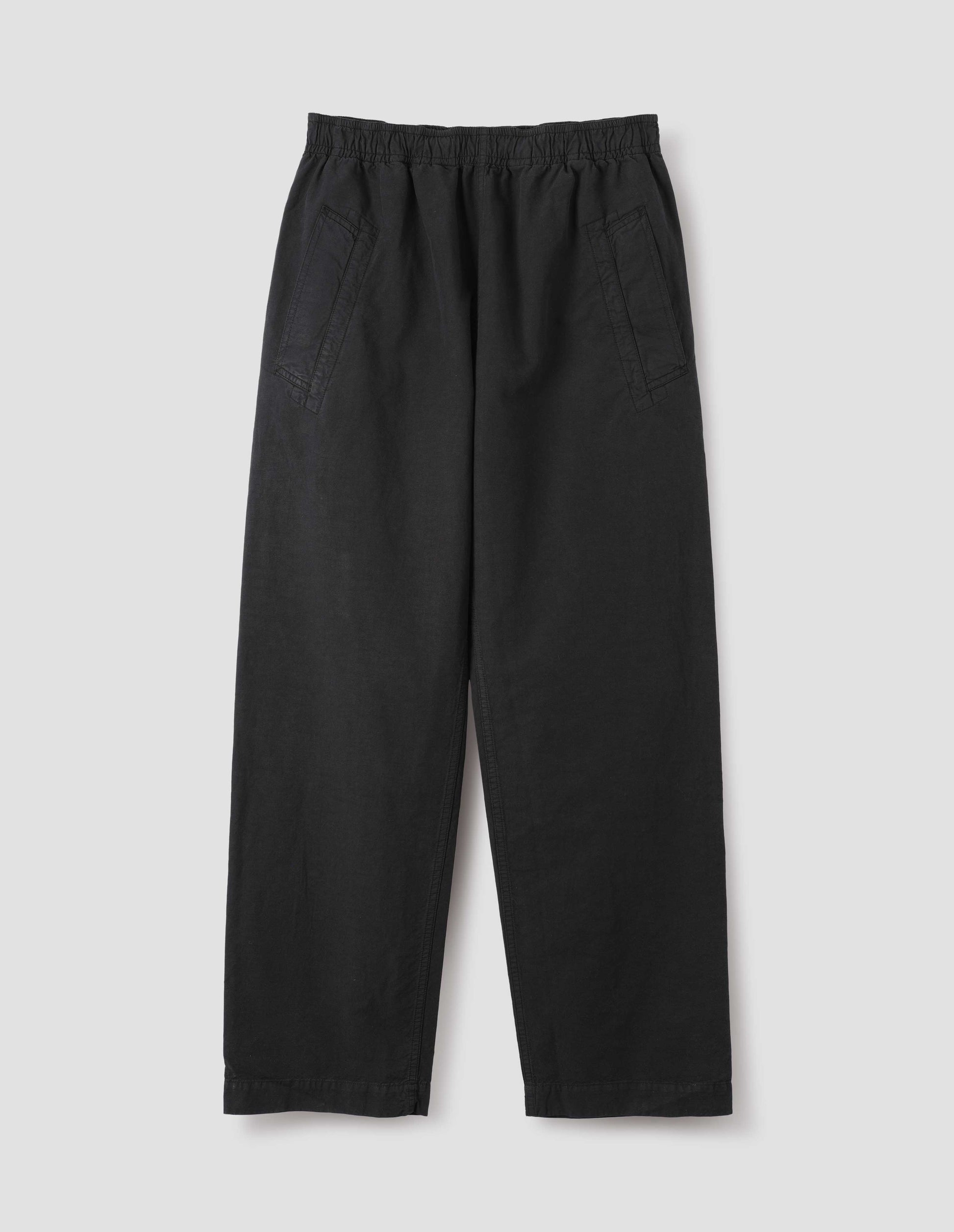 Black joggers with elasticated waist and deep welt pockets. Front flat lay view.