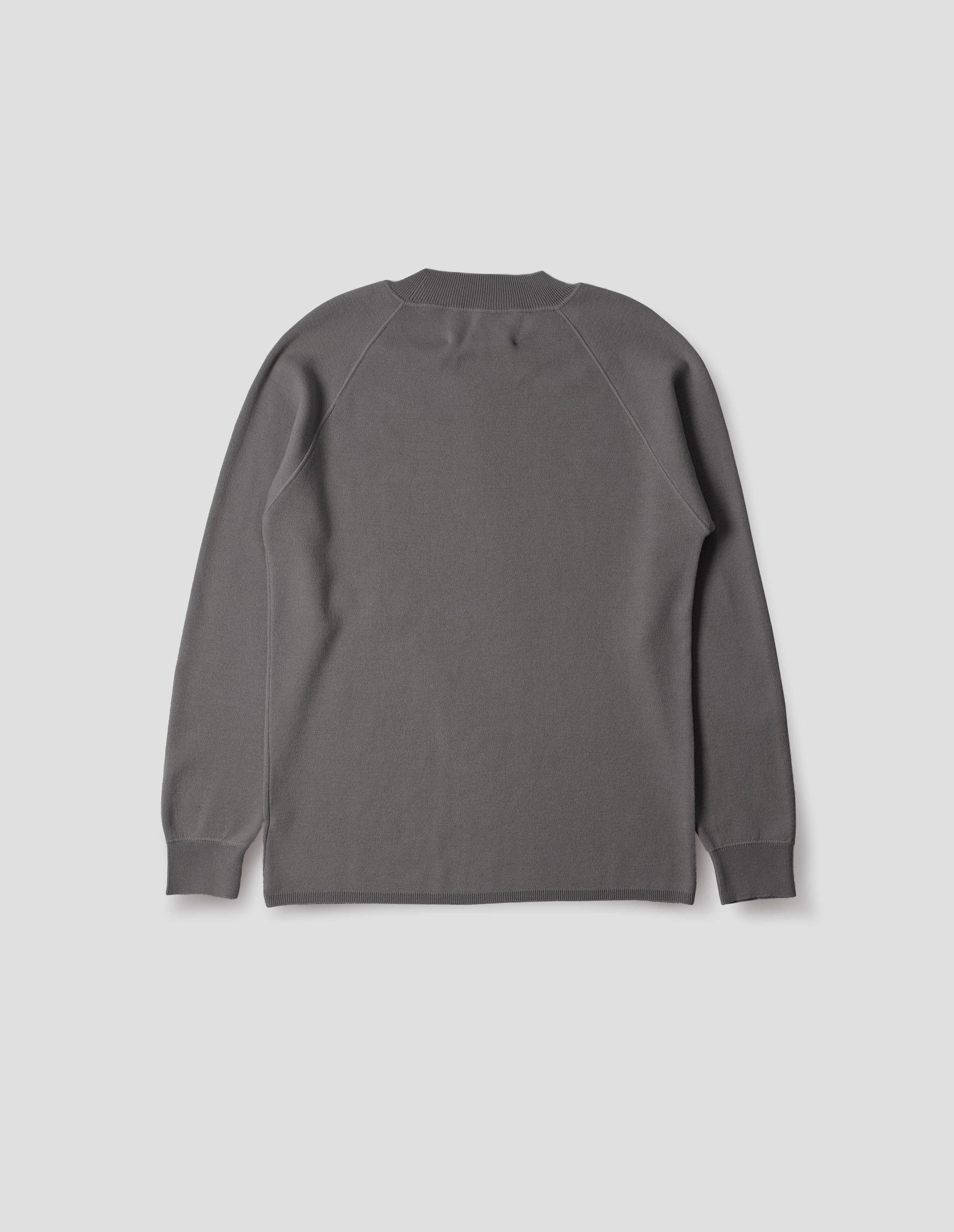 Light grey merino wool sweatshirt with raglan sleeve and contrast rib on neck, cuffs and hem. Back flat lay view.