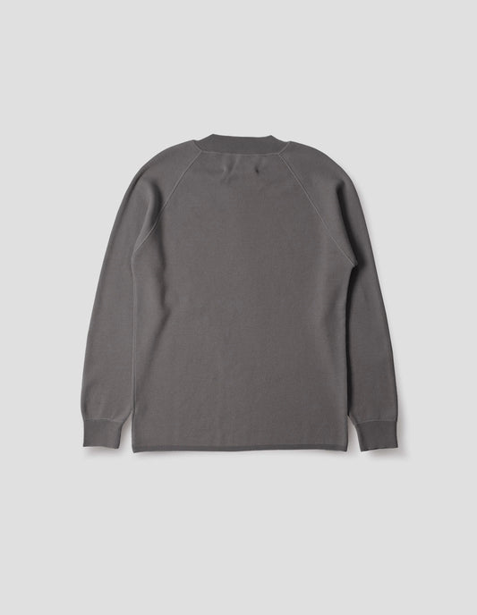 Light grey merino wool sweatshirt with raglan sleeve and contrast rib on neck, cuffs and hem. Back flat lay view.