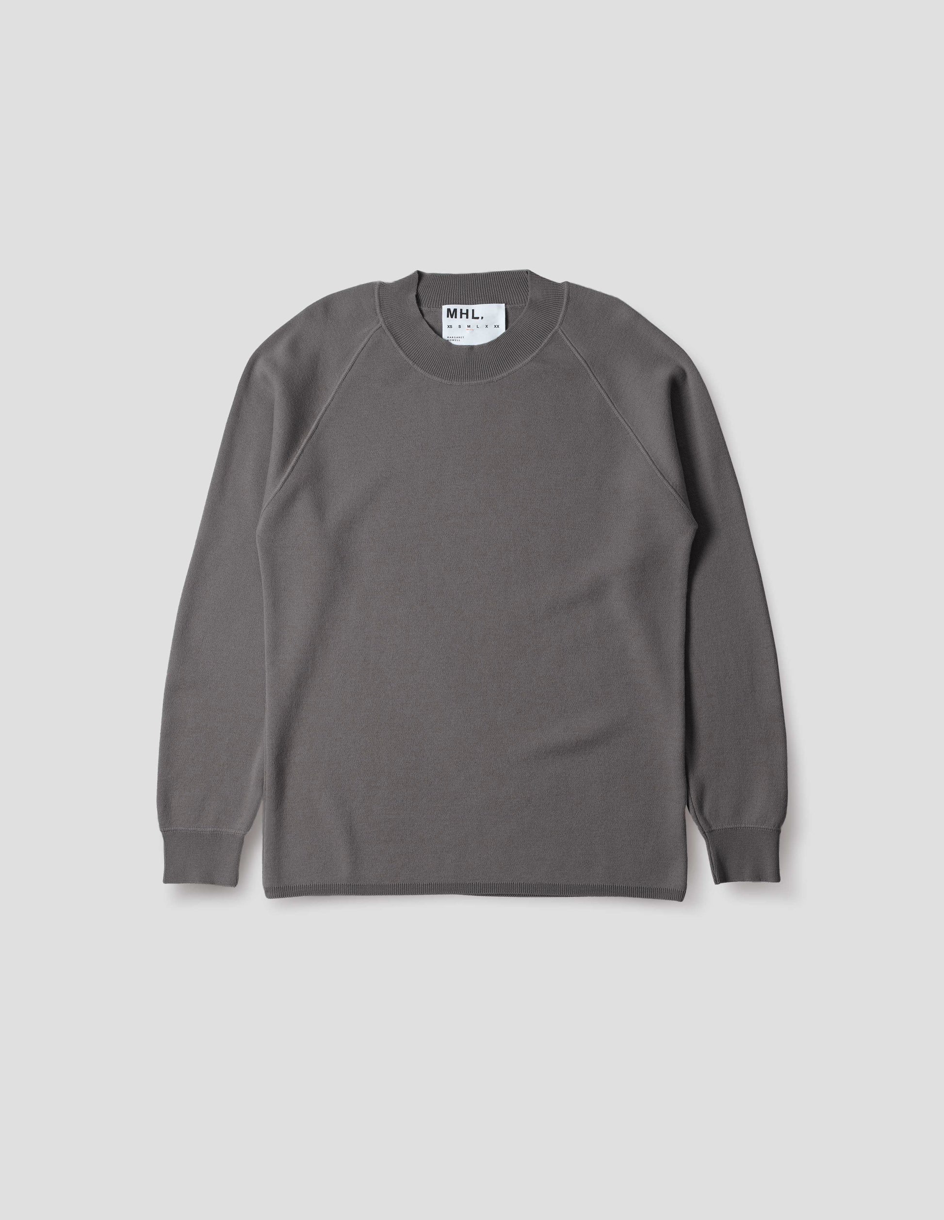 Light grey merino wool sweatshirt with raglan sleeve and contrast rib on neck, cuffs and hem. Front flat lay view.