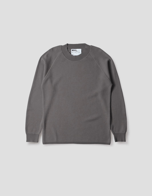 Light grey merino wool sweatshirt with raglan sleeve and contrast rib on neck, cuffs and hem. Front flat lay view.