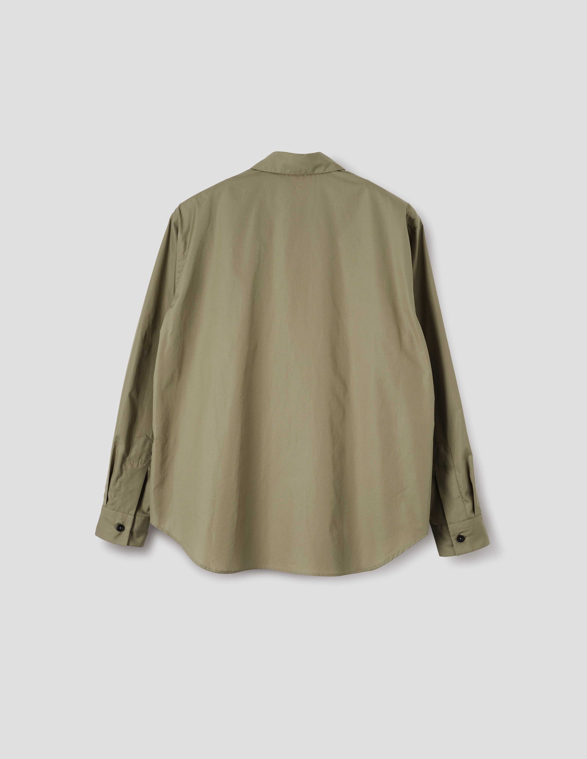 Beige cotton poplin long sleeve shirt, with horn button closure on cuffs and curved hem. Back flat lay view. 