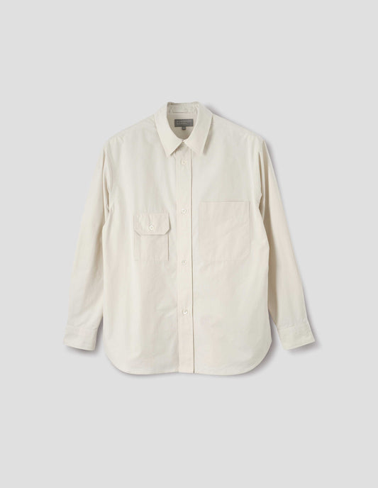 White long sleeve cotton shirt with patch pocket and button-through flap pocket on chest and raised placket with mother of pearl buttons. Front flat lay view.