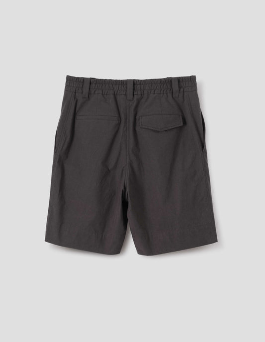 Dark brown cotton shorts with half elasticated waistband, belt loops and concealed button fastening flap back pockets. Back flat lay view. 