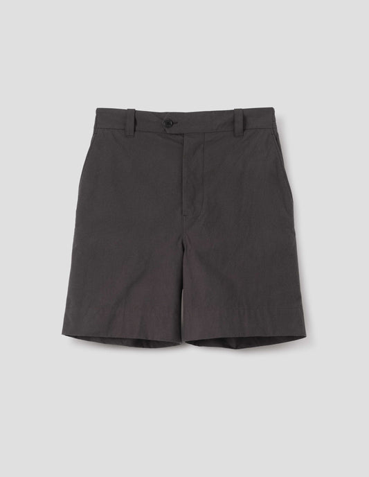 Dark brown cotton shorts with belt loops, button fly with button tab fastening and slant pockets. Front flat lay view. 