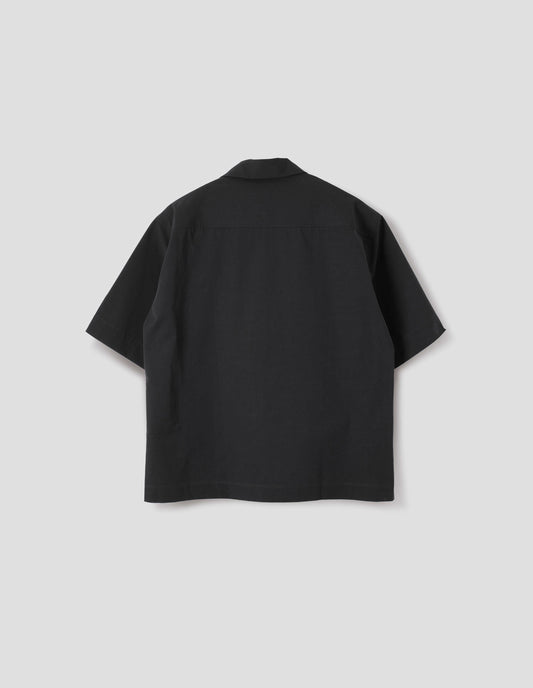 Black short-sleeved shirt with side split hem. Back flat lay view. 