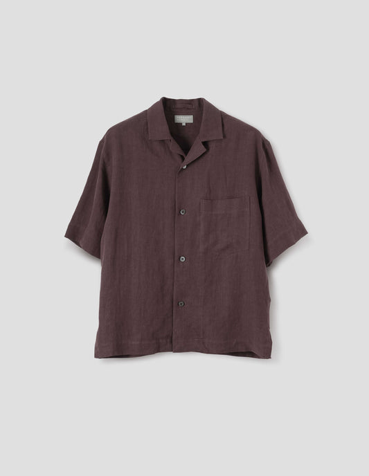 Brown short-sleeve shirt with revere collar, mother of pearl buttons, chest patch pocket and side split hem. Front flat lay view.