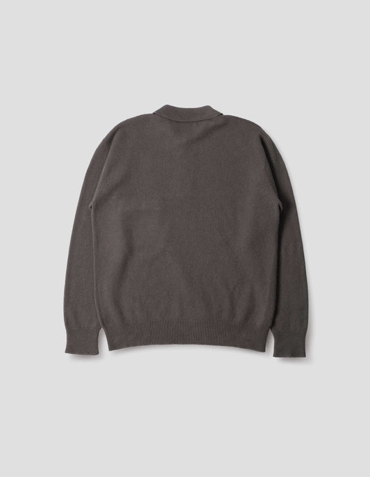 Dark grey merino cashmere polo shirt with dropped sleeve and rib collar, cuffs and hem. Back flat lay view.