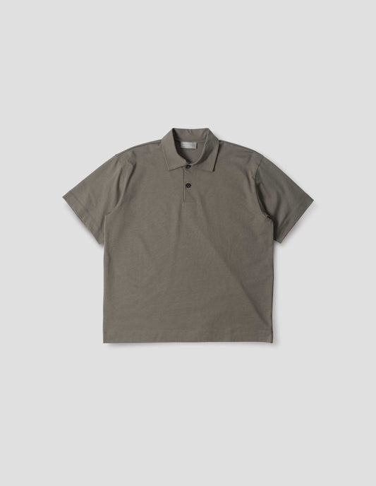 Greyish green cotton short sleeve polo shirt with wide placket and horn buttons. Front flat lay view. 