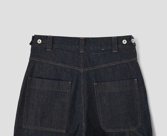 Indigo blue denim twill jeans. With metal button tab waist adjusters, belt loops and patch and hammer pocket on back of trousers. Back flay lay view.