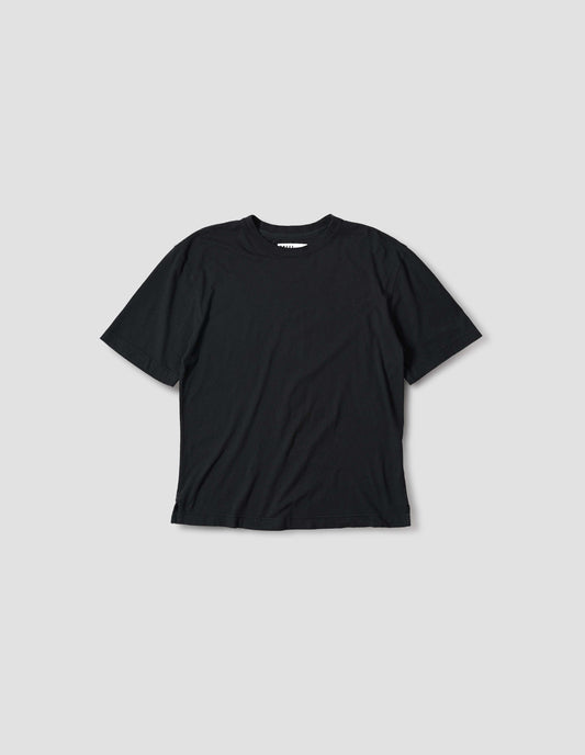 Black t-shirt with herringbone tape detailing on inside neck and vent split hem. Front flat lay view.