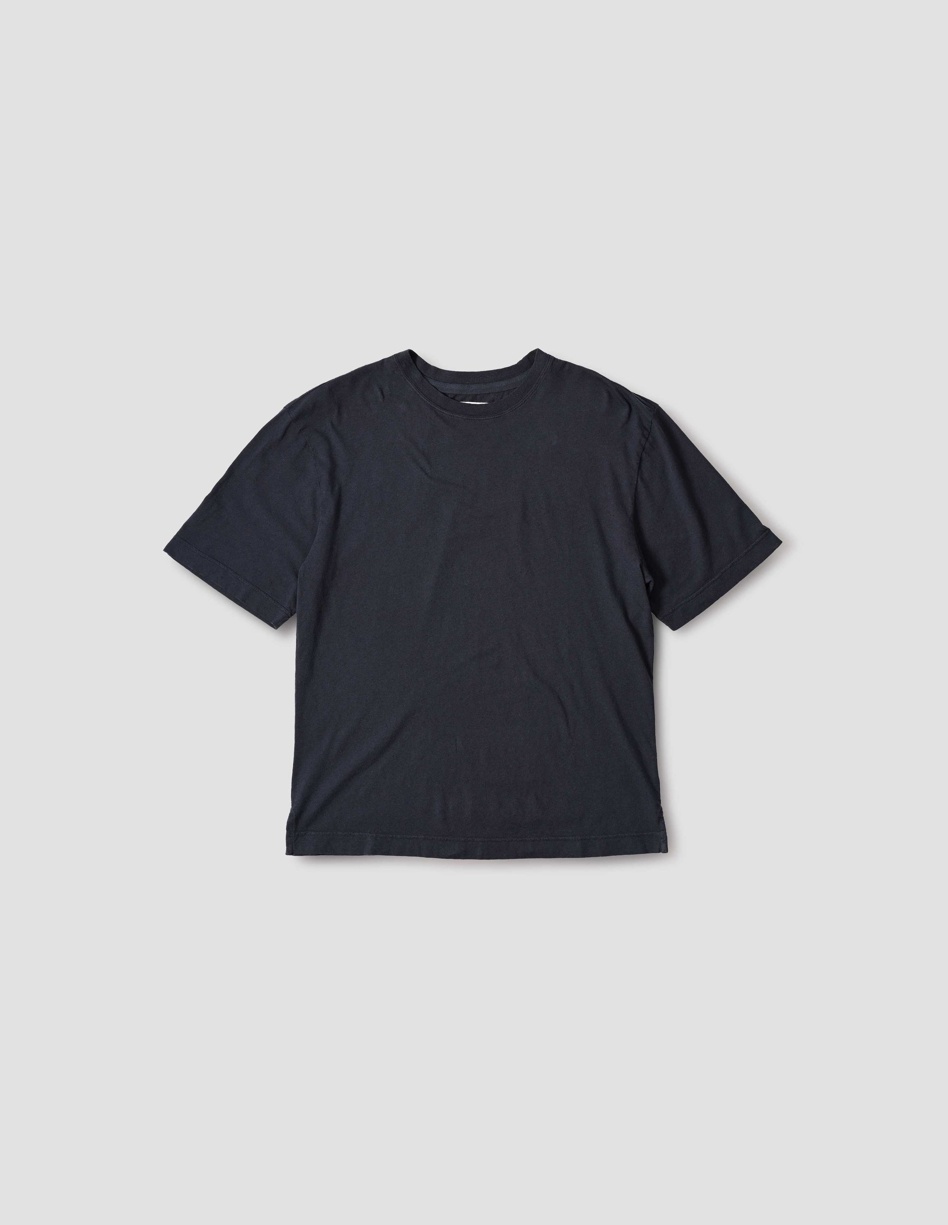 Navy t-shirt with herringbone tape detailing on inside neck and vent split hem, front flat lay view.