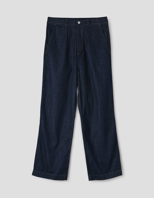Dark blue pleated denim twill trousers with wide straight leg, high waist, metal button fly and belt loops, and curved slant pockets. Front flat lay view.