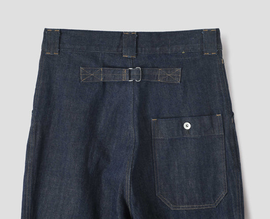 Indigo blue denim twill jeans. With metal cinch on back, wide belt loops and dropped metal button through patch back pocket. Back flay lay view.
