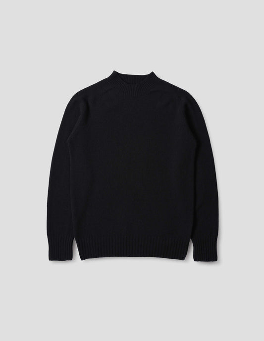 Dark navy wool and cashmere jumper, with saddle sleeve, contrast rib on neck, cuffs and hem. Front flat lay view.