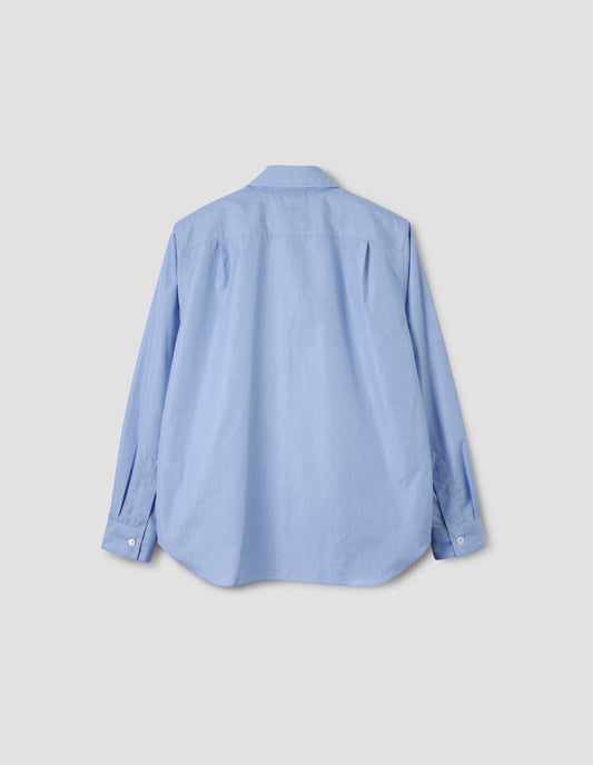 Pale blue cotton shirt, with curved hem, pleats on back yoke and mother of pearl button cuffs. Back flat lay view.