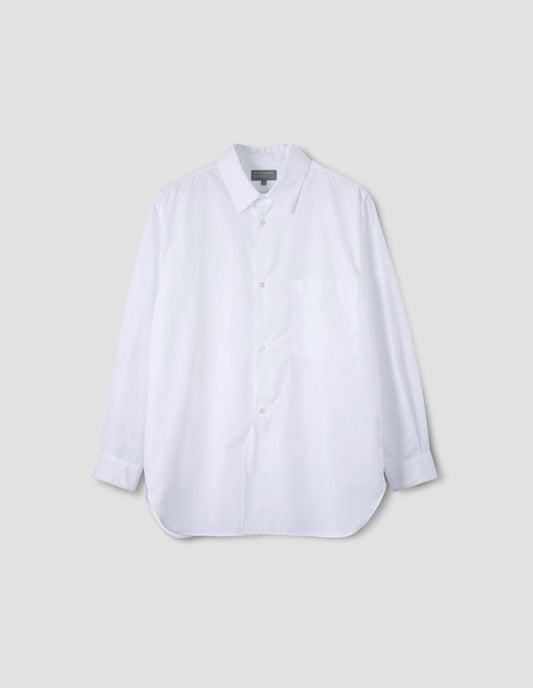 White cotton shirt with chest pocket, curved hem, curved placket from waist to hem and mother of pearl buttons. Front flat lay view.