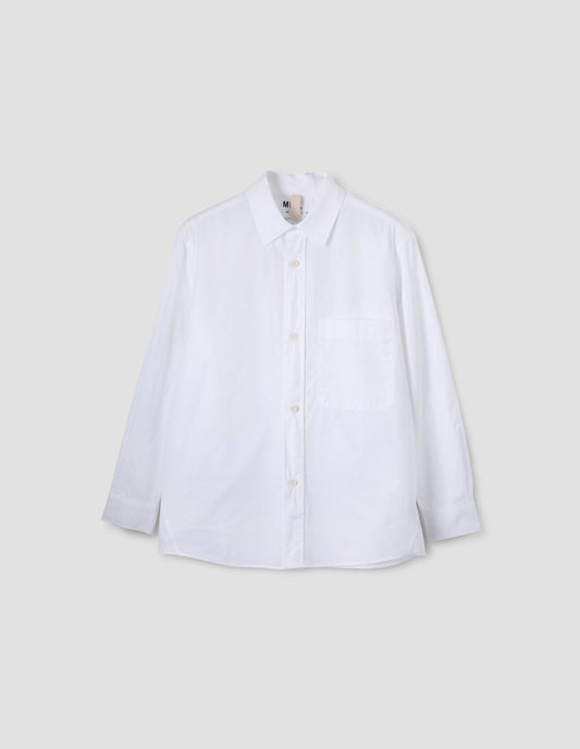 White shirt with  raised placket, chest pocket and corozo brace buttons. Front flat lay view.
