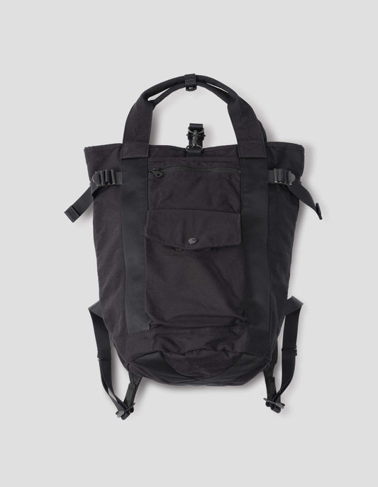 Black backpack with contrast webbing on handles and shoulder straps, side strap adjustors, popper and zip fastening pockets. Front flat lay view above.