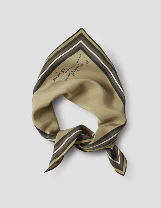 Light green folded and tied silk neck scarf with white, brown and dark green contrast borders, hand rolled edges and Margaret Howell logo. Close up flat lay view.
