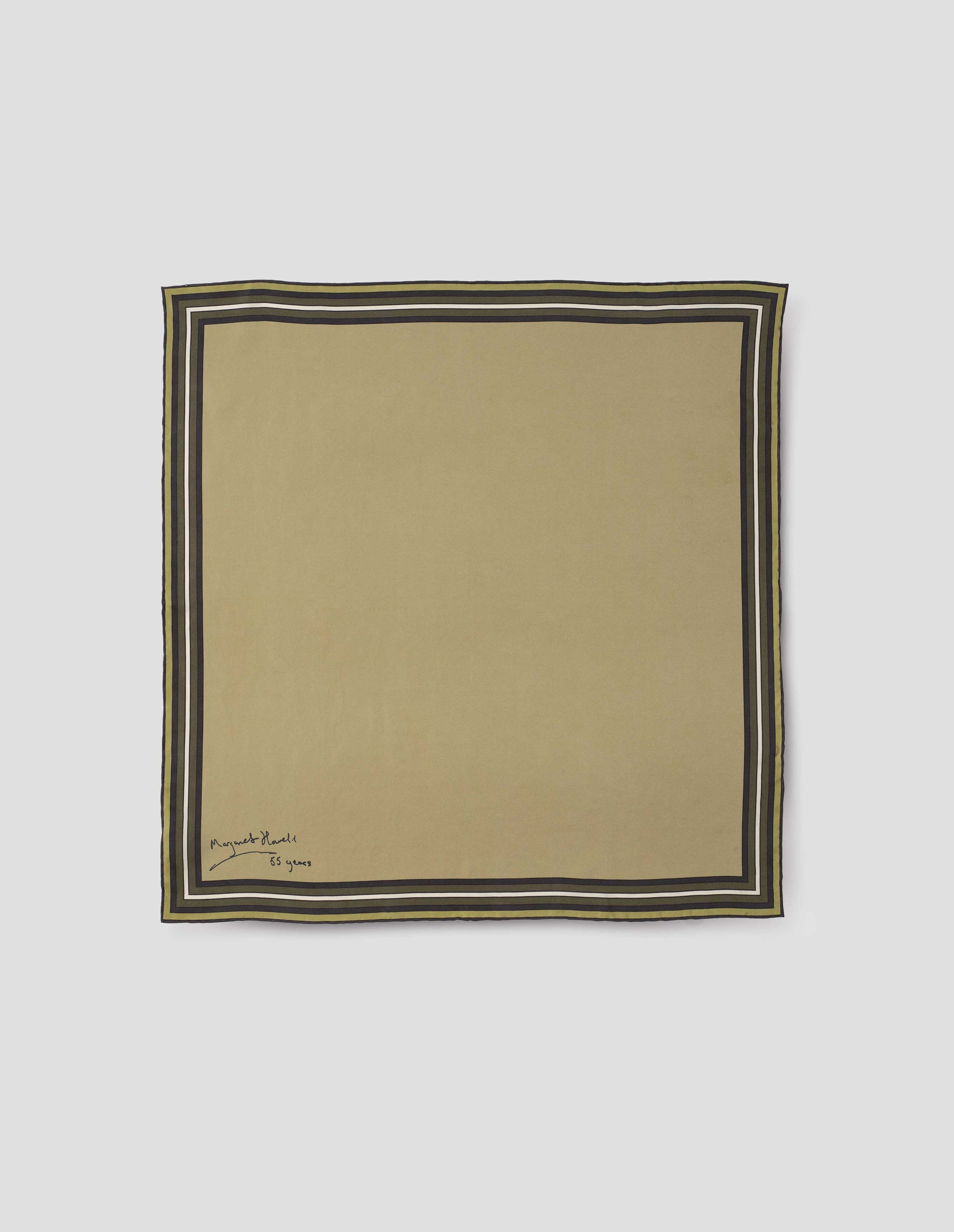 Light green square silk neck scarf with white, brown and dark green contrast borders, hand rolled edges and Margaret Howell logo. Front flat lay view.