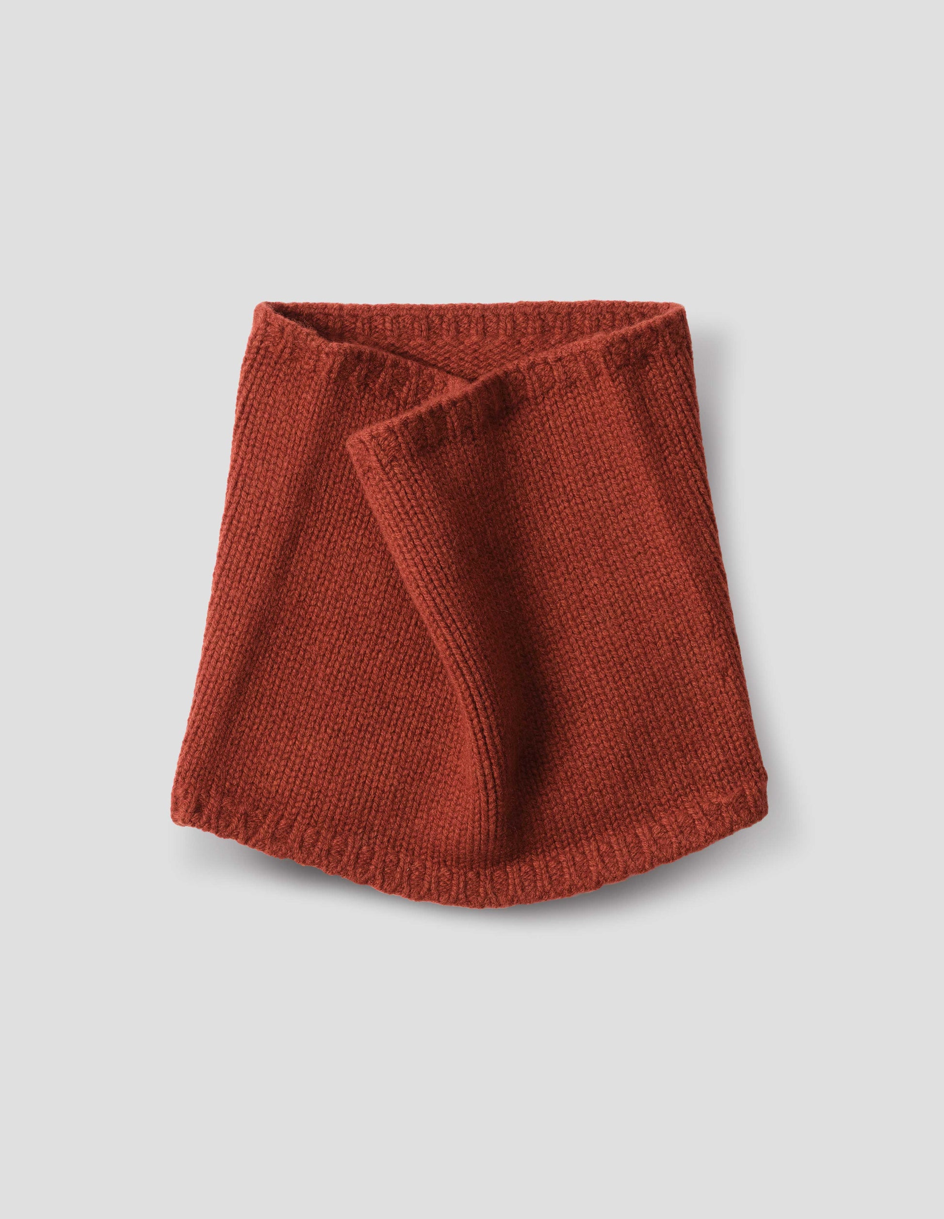 Red merino cashmere knitted neck warmer with contrasting rib tipping. Front flat lay view.