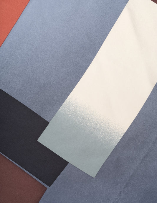 Orange-red silk scarf with beige, blue, black and brown collage print fabric swatch.