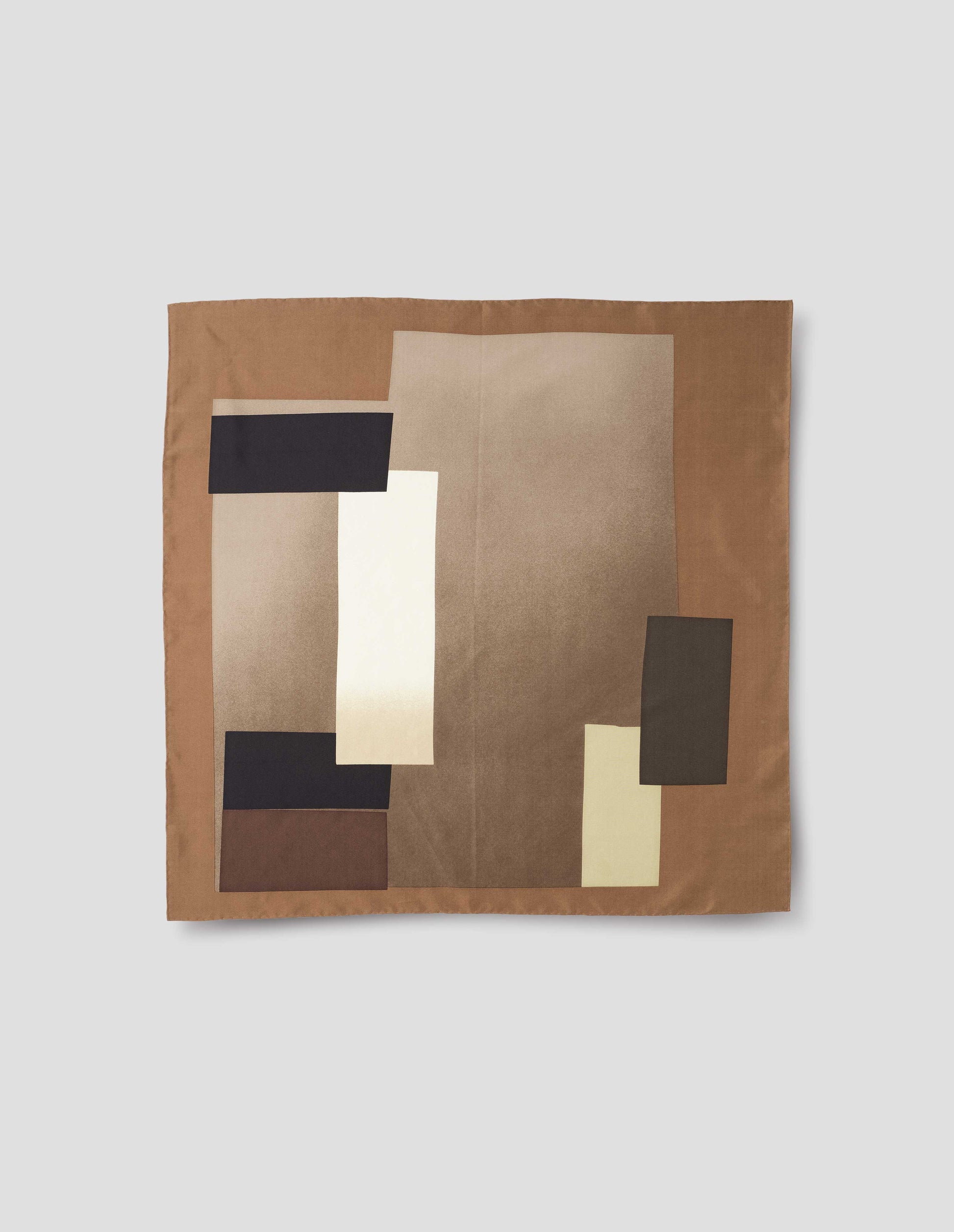 Light brown square neck scarf with contrast beige, brown and black collage print and hand rolled edges. Front flat lay view.