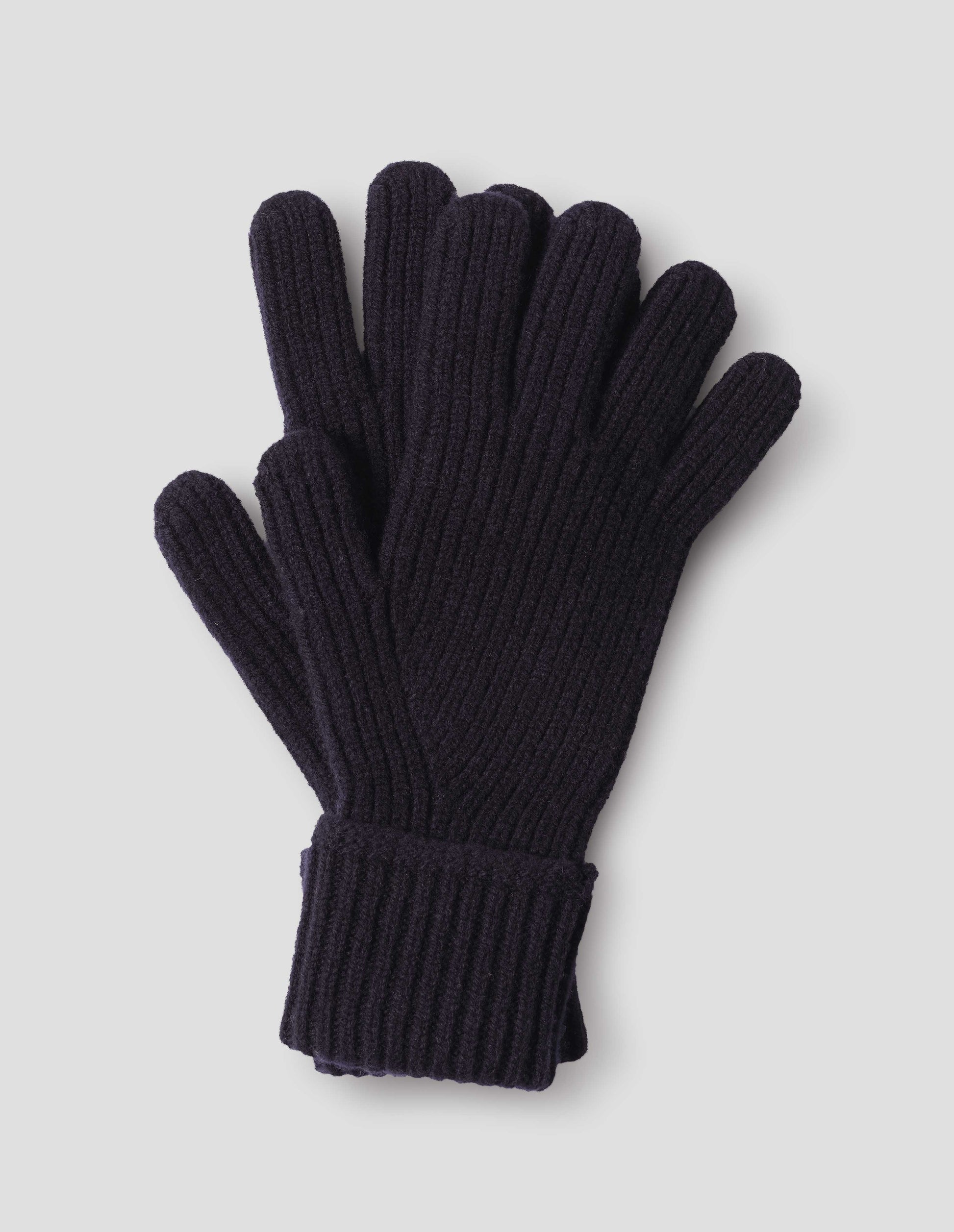 A pair of navy blue rib knitted merino wool gloves, front flat lay view. 