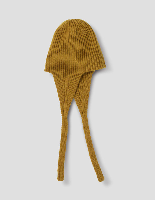 A yellow rib knitted hat with ear flaps and tie detail, side flat lay view.