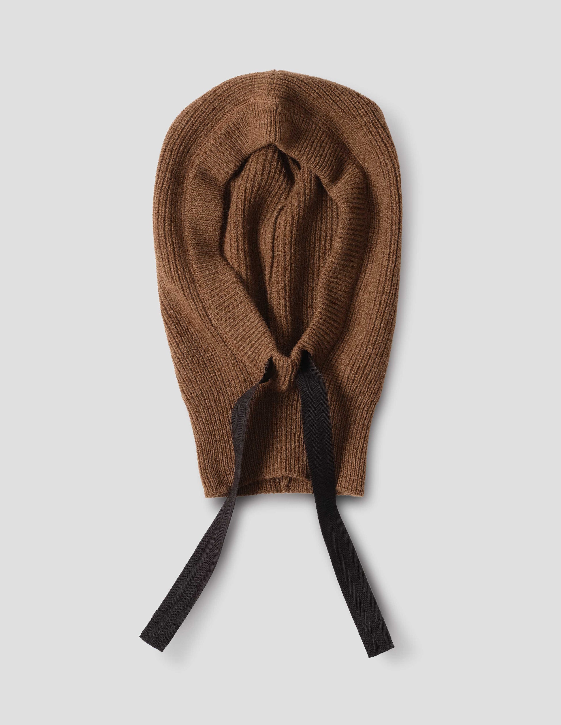 Brown knitted wool hood with contrasting black herringbone tape to adjust and contrast rib on face, front flat lay view.