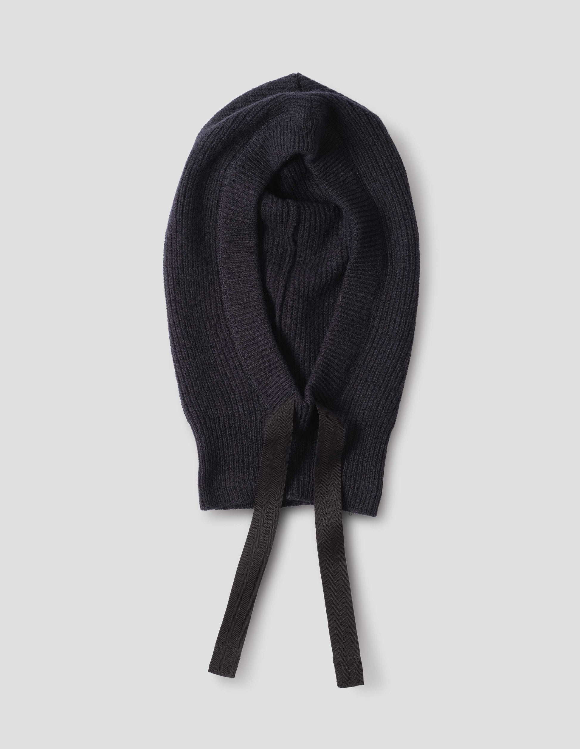 Dark navy blue wool hood with contrasting black herringbone tape to adjust and contrast rib on face, front flat lay view.