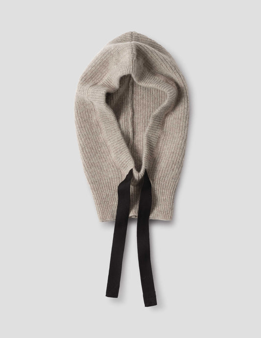 Beige knitted wool hood with contrasting black herringbone tape to adjust and contrast rib on face, front flat lay view.