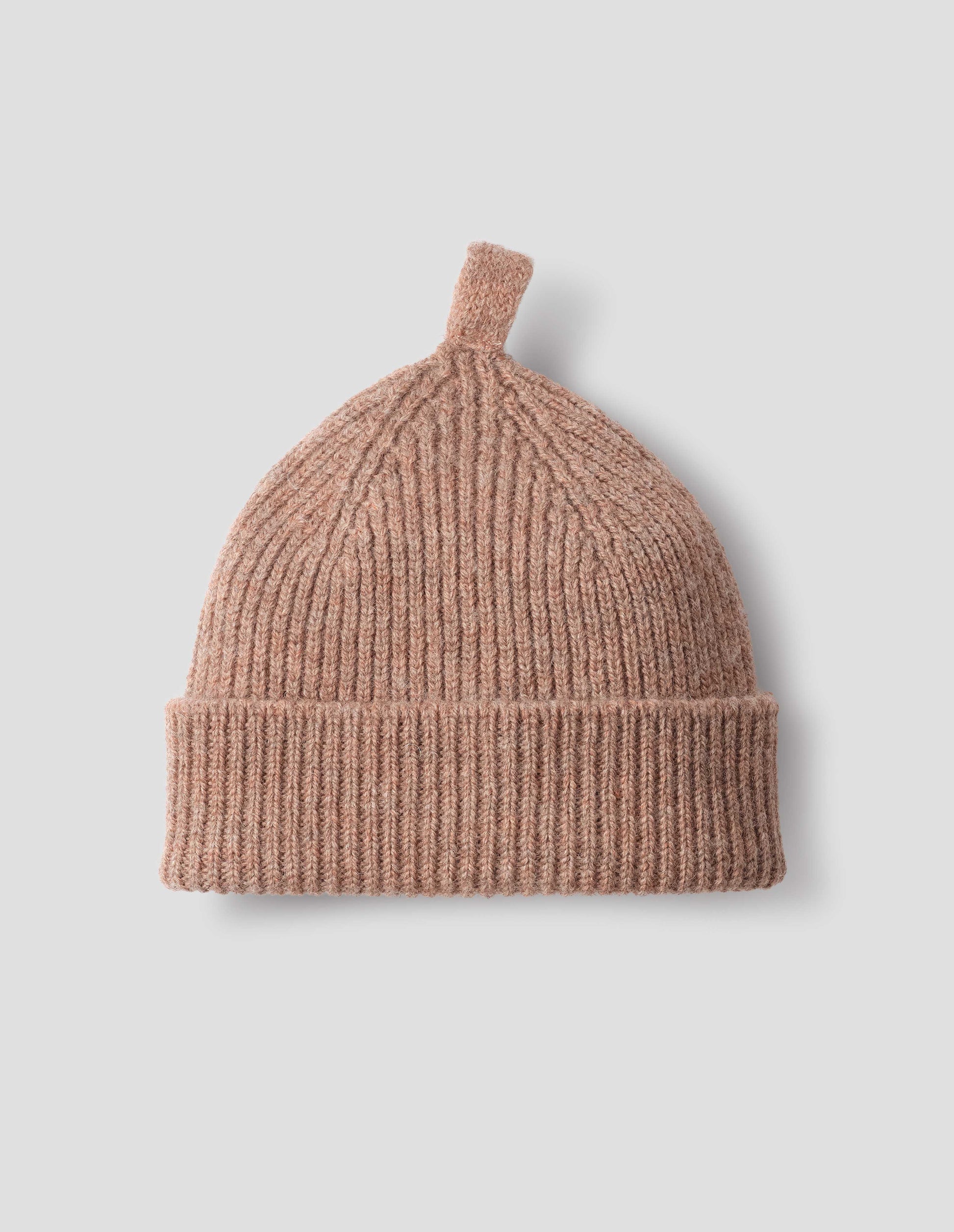 Pinkish beige wool ribbed hat, with knitted loop detailing on top, front flat lay view. 