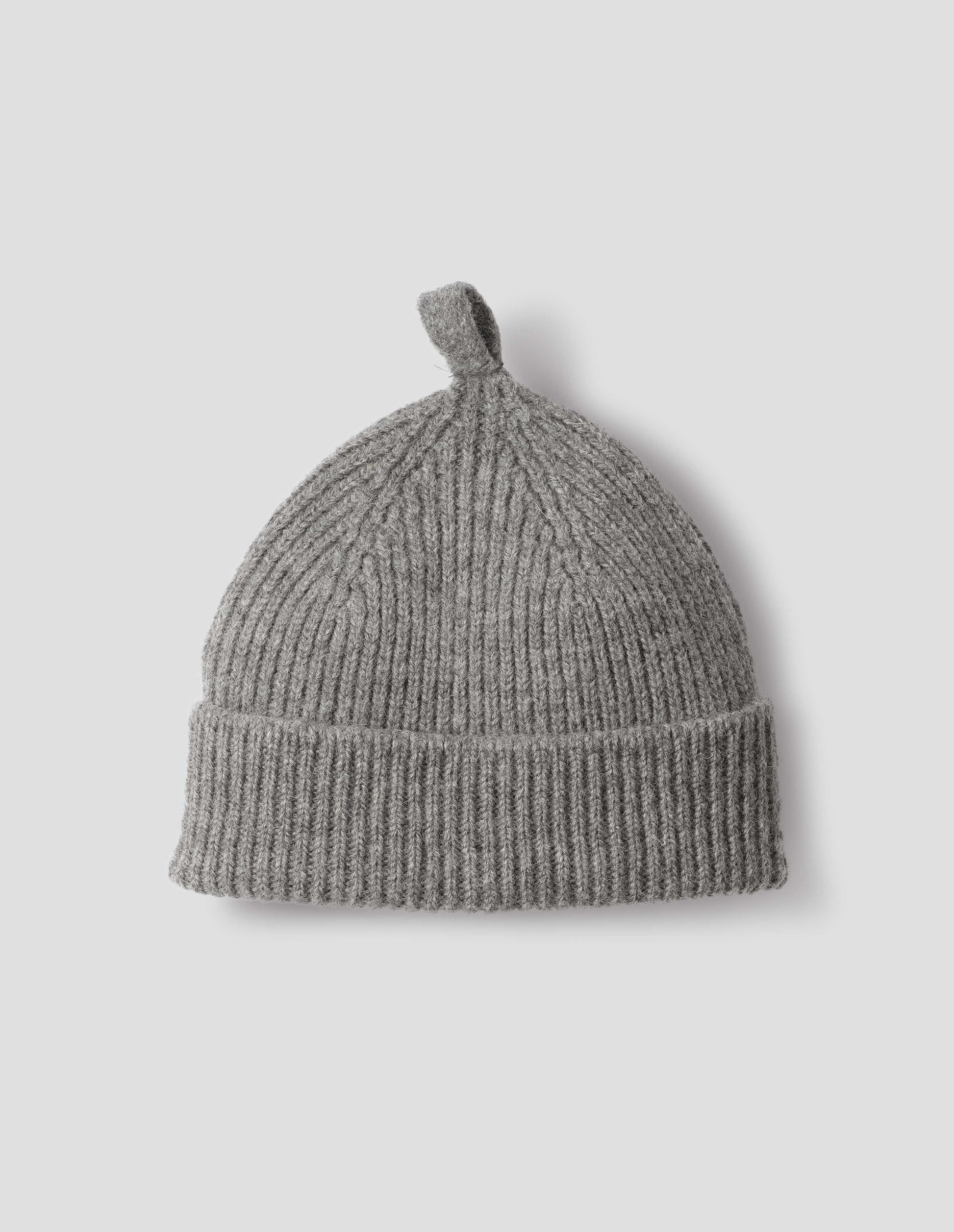 Grey wool ribbed hat, with knitted loop detailing on top, front flat lay view. 