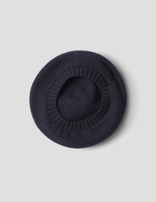 Dark navy wool tam o shanter hat with contrast ribbing. Back flat lay view.