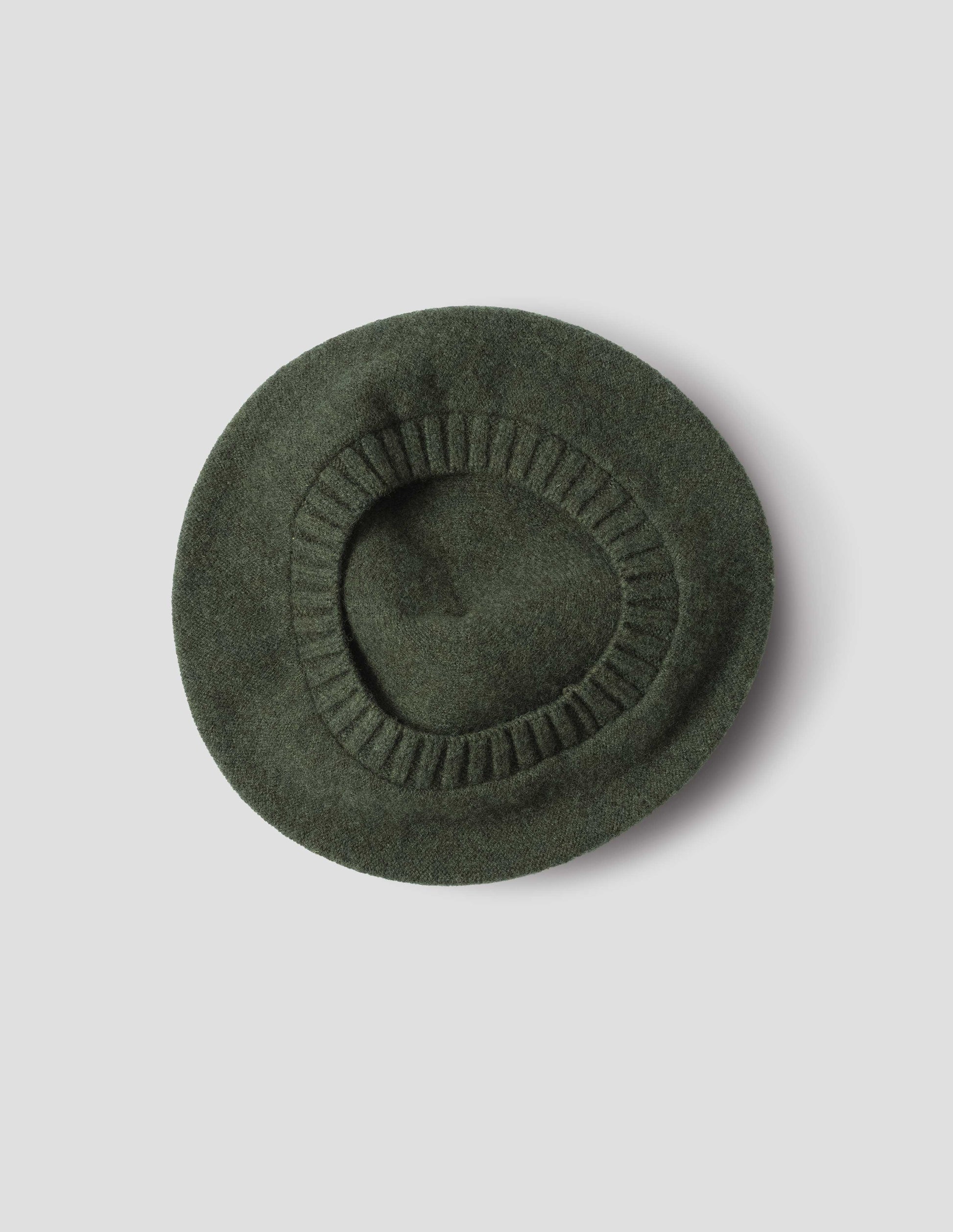 Green wool tam o shanter hat with contrast ribbing. Back flat lay view.