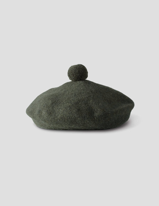 Green wool tam o shanter hat with matching pom pom bobble in centre. Front flat lay view.