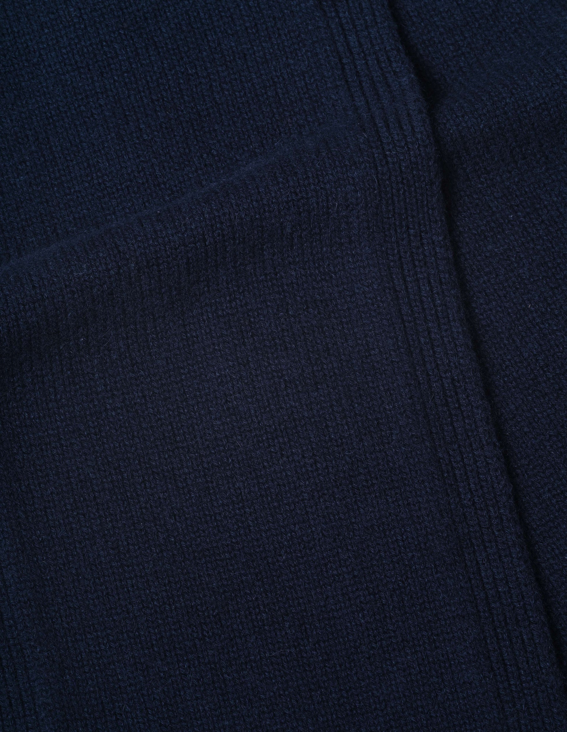Dark navy blue knitted cashmere scarf, fabric swatch.