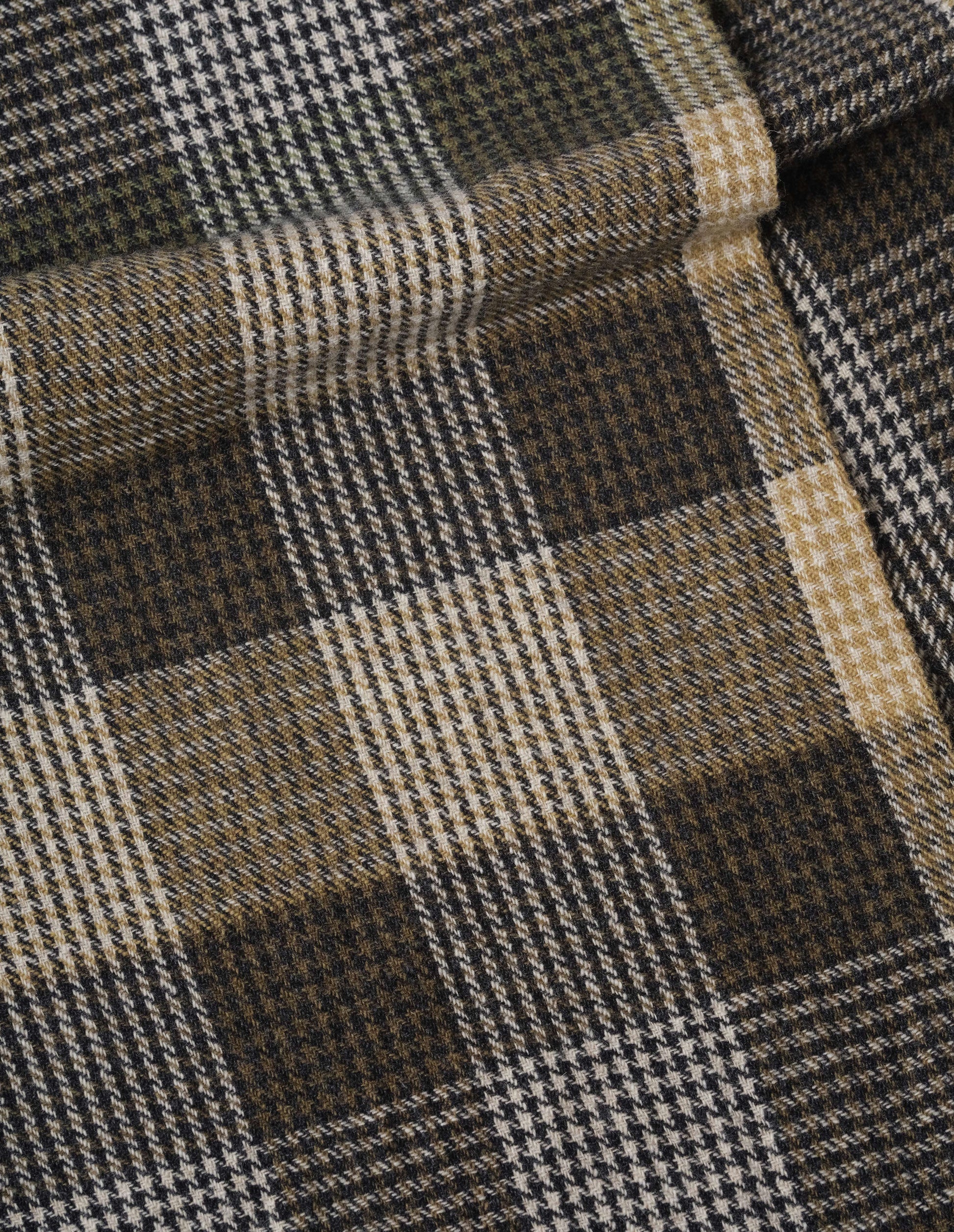 Handwoven puppytooth overcheck scarf in khaki and black with hints of white and yellow, fabric swatch.