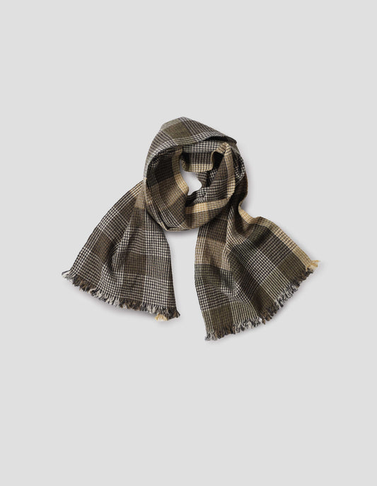 Handwoven puppytooth overcheck scarf in khaki and black with hints of white and yellow, front flat lay view.