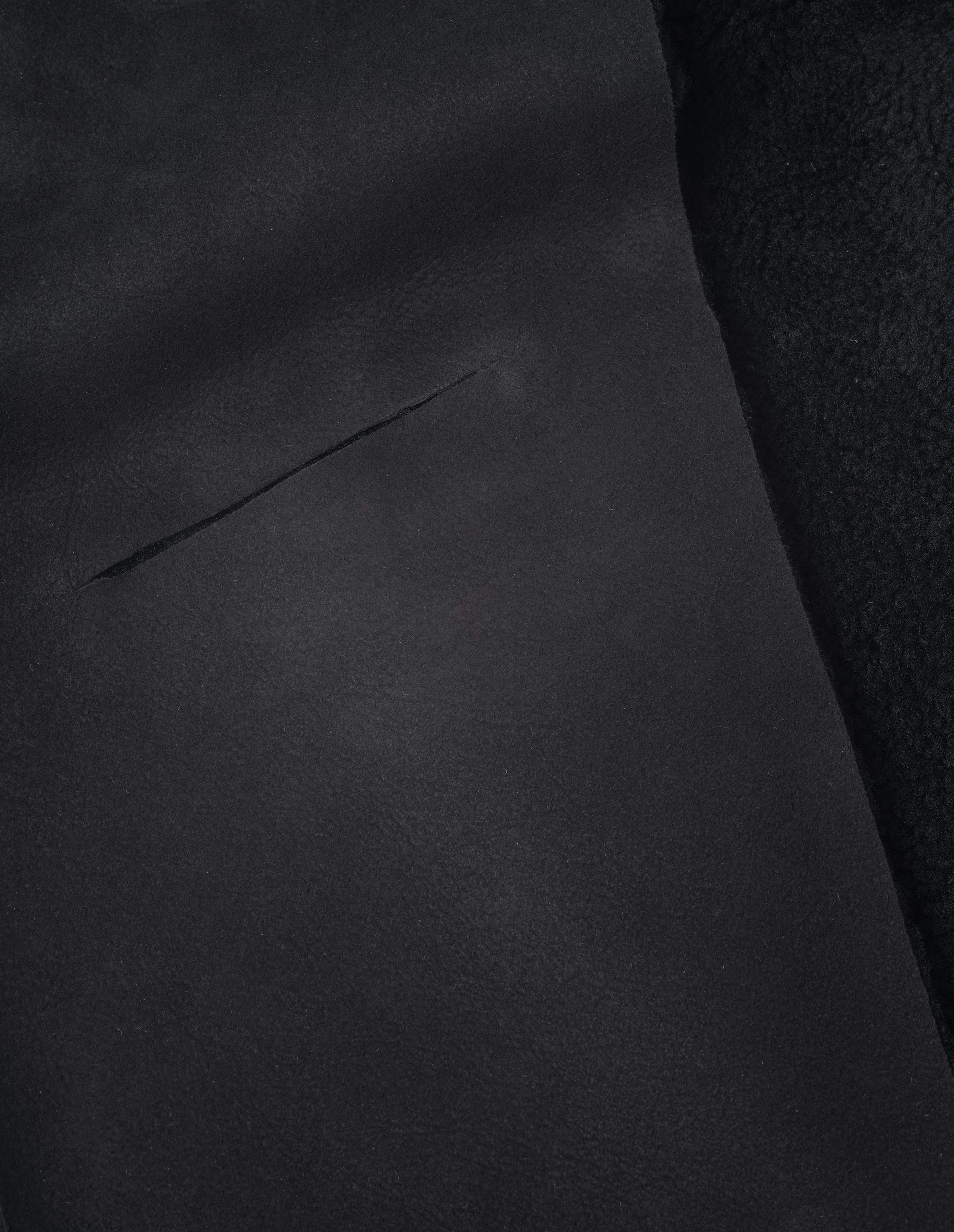 Black curly merino shearling scarf fabric swatch.